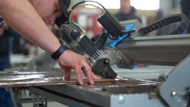 Worker Cutting Ceramic Tile with Wet Tile Saw