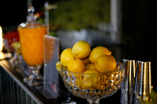 Crystal bowl filled with fresh yellow lemons for table and bar decoration