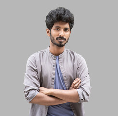 Obraz premium Portrait of handsome smiling young man with folded arms. Laughing joyful cheerful men with crossed hands studio shot. Isolated on gray background