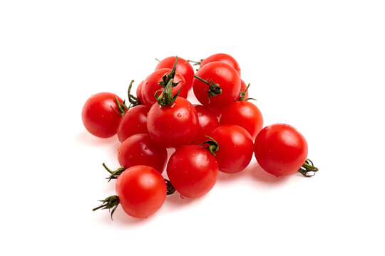 Fresh red cherry tomatoes arranged in a cluster on a white background, showcasing their vibrant color and smooth texture with green stems attached