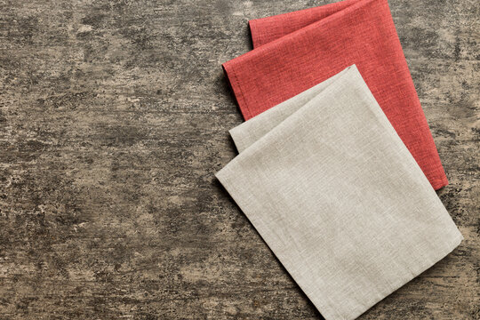 top view with gray kitchen napkin isolated on table background. Folded cloth for mockup with copy space, Flat lay. Minimal style