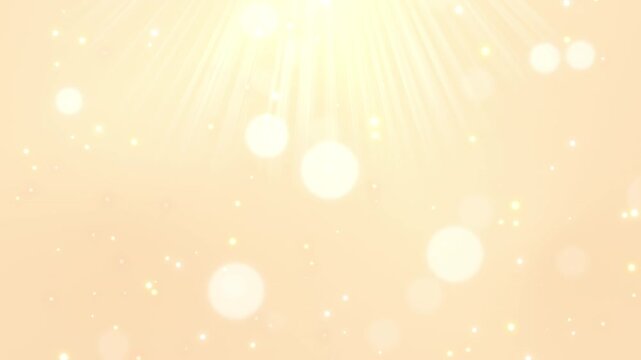 美しいゴールドの背景に差し込む光とキラキラの動画素材 / Beautiful golden light rays and fluffy floating bubbles loop video