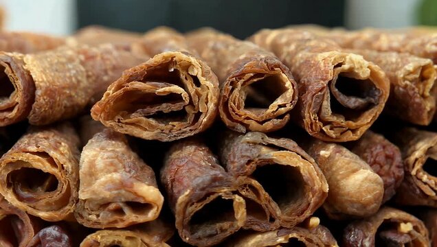 High resolution 4K stock video displaying an orderly pile of handmade sweet dried fig rolls showcasing their detailed texture and wholesome appeal perfect for artisanal bakery advertisements recipe