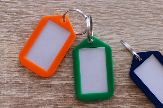 Blank Plastic Key Tag Mockup Set with Colourful Keychains. Closeup.