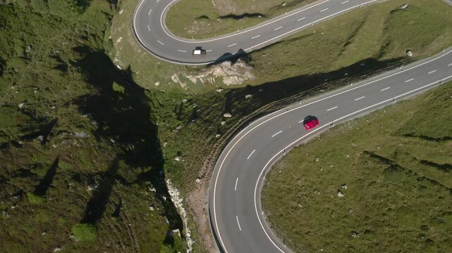 Winding mountain road in the Alps with cars driving, Albula Pass, Switzerland