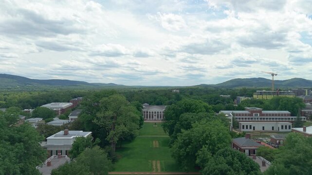 Charlottesville, Virginia, smooth 4K aerial drone video flying forward over the Lawn toward Old Cabell Hall and the surrounding University of Virginia campus on an overcast summer day.