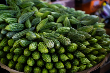 Fresh bitter melon at market © ProShine Studio