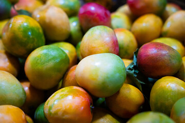 Colorful ripe mangoes at market © ProShine Studio