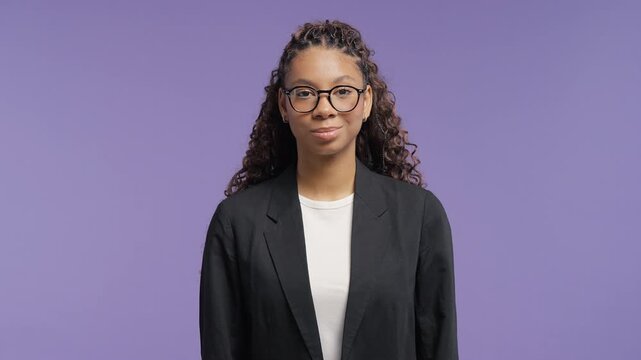 Serious african american school girl looking directly at the camera with a composed expression. Confidence, leadership, resilience, self control and authentic personality.