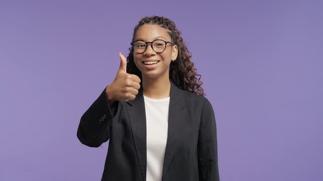Happy college student showing a thumbs up with a confident smile. Young woman approving a great choice, success, recommendation and positive feedback.
