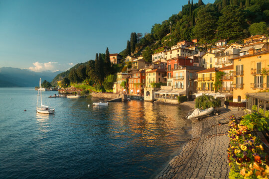 Historic town of Varenna along the shores of famous Lago di Como illuminated in golden evening light at sunset, Lombardy, Italy