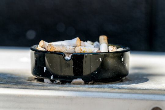 An ashtray full of stubbed out cigarettes