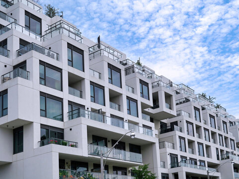 white apartment building with staggered balconies