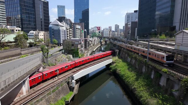 Famous subway and railroad intersection near Ochanomizu Station and Akihabara showing multiple trains passing simultaneously in central Tokyo, Japan.