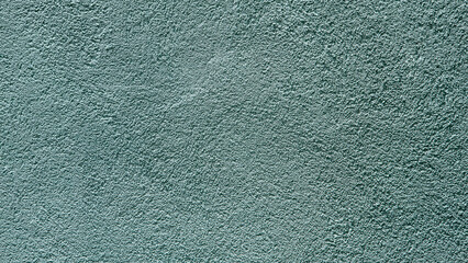 Abstract light blue- green stucco wall texture background with a subtle rough finish and copy space. © Saminda