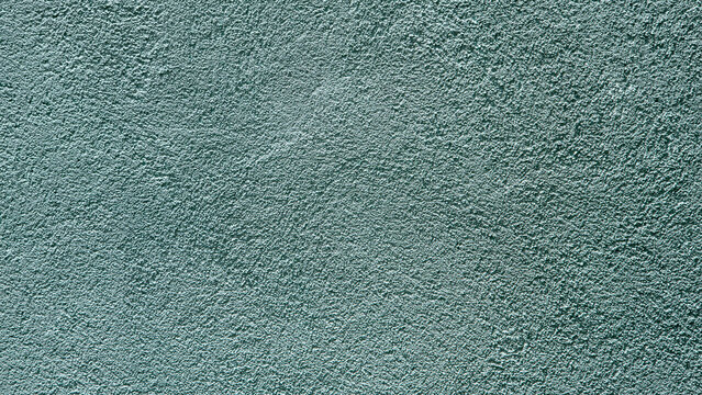 Abstract light blue- green stucco wall texture background with a subtle rough finish and copy space.