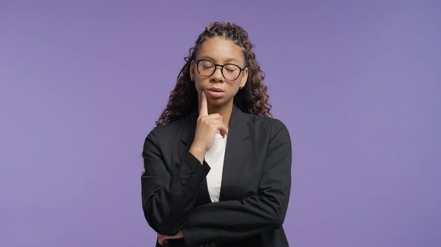 Thoughtful college student looking up while searching for a solution. Young african woman planning, analyzing opportunities and making an important decision.
