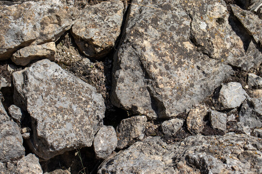 Detailed texture of mountain rocks and cliff stones in Sairam Su gorge, Kazakhstan. Natural rocky background showing rough geological formations and stone surfaces in Central Asia.