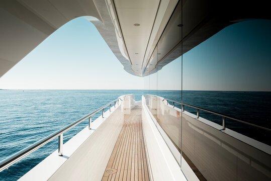 Beautiful detail of a superyacht upper deck corridor reflection on the glass windows, featuring the yacht's architectural design