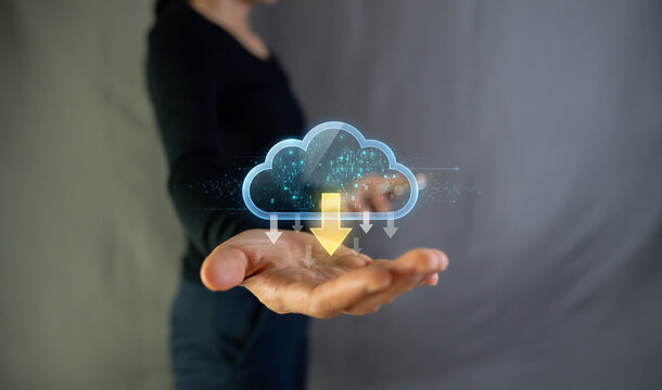 Woman holding glowing cloud icon with download arrow, cloud computing and data storage concept