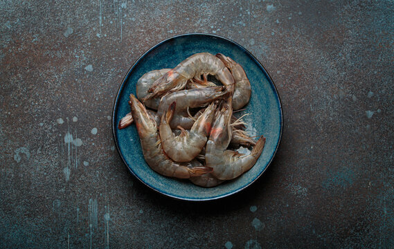 Fresh raw shrimps prawns plate dark background seafood uncooked healthy