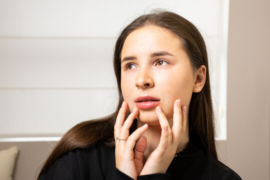 A picture of a very beautiful and attractive young lady, a portrait showing how satisfied she is after the lip rejuvenation procedure. This look is very popular on the market, attractive to clients.
