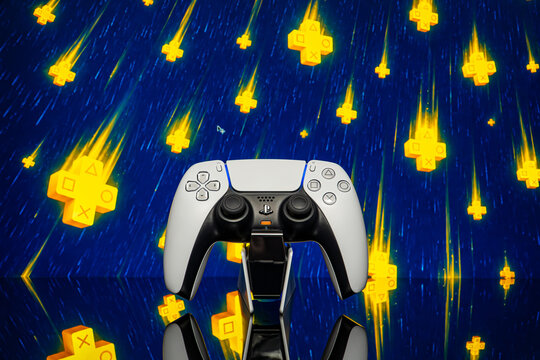 July 25, 2026, Odessa, Ukraine.  Sony PS5 controller with falling yellow PlayStation Plus symbols on blue back
