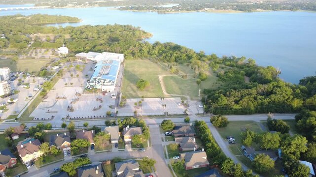 Prominent municipal water park structures overlook open parking lots by dense tree canopies bordering Lewisville Lake in Lakewood Estates. Regional documentation concludes across Little Elm, DFW