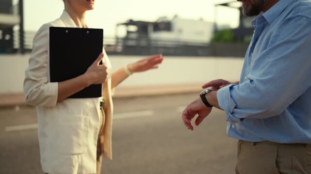 Unhappy male client gesturing angrily while arguing with female architect or contractor about project delays on a new construction site, showing frustration and dissatisfaction