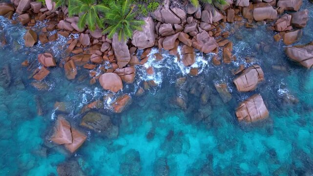 Aerial View of La Digue Coastline with Turquoise Ocean and Granite Rocks