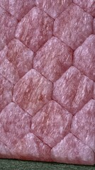 Obraz premium Pink quilted padding arranged in hexagon pattern close up