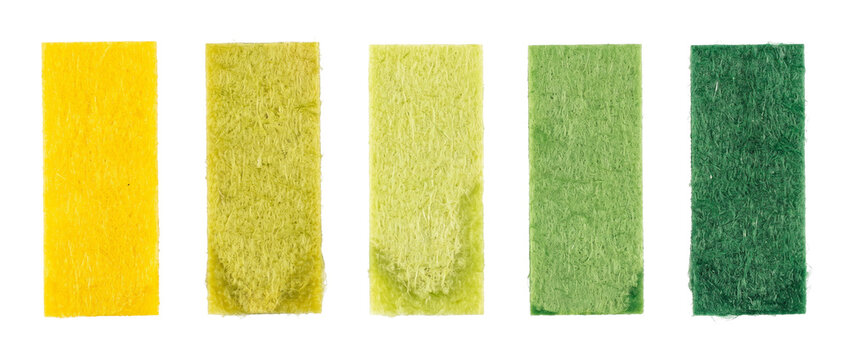 Litmus paper pH test strips showing color change scale on black background for chemical analysis, acidity level testing, scientific laboratory experiment, health diagnostics, and water quality measure