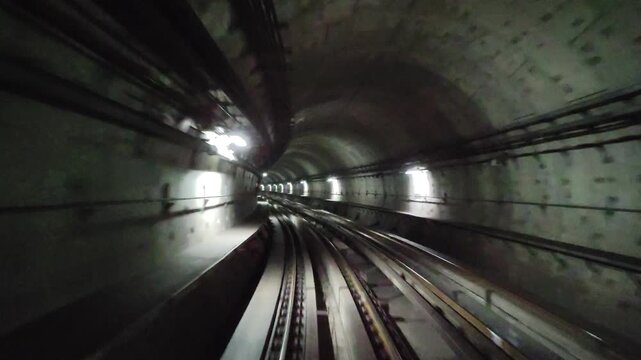 Journey through a subway tunnel in a city at night