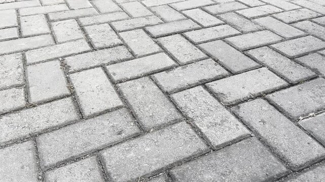 Close up high angle view of grey interlocking concrete pavers