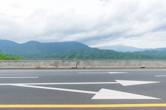 Asphalt road side view and beautiful natural panoramic countryside landscape with mountains.