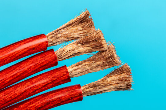 Copper wire insulated with red rubber on a blue background.