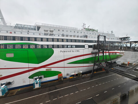 Helsinki, Finland-Nov. 29th 2025: Side profile of the LNG-powered ferry Tallink Megastar docked at the port terminal with a passenger gangway under an overcast sky in Helsinki.