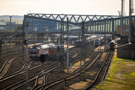 Poprad, Slovakia - July 25, 2026: Wide high-angle view of multiple railway tracks, catenary wires, and modern station building at Poprad-Tatry railway station.
