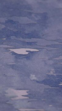 Vertical Panning Shot Of Abstract Blue Water Wave Pattern Background