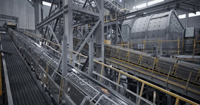 Industry conveyor belt system transporting ore through industrial processing plant, Concentration factory.