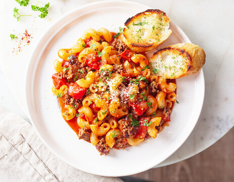 American goulash made from macaroni pasta with tomatoes, red sauce, grated parm cheese. AI