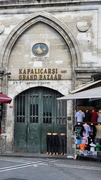 Entrance to Kapalicarsi Grand Bazaar in Istanbul showing shops and clothing displays