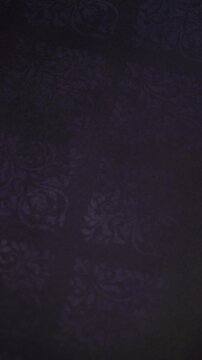 Vertical Macro Shot of Moody Indigo Floral Damask Pattern on Dark Textile