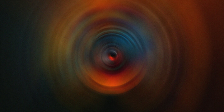 Abstract dark background with glowing orange circular light vortex center.