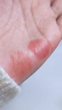 Top view of palm with colorful pattern on skin. Artistic swatch or lip tint color application for beauty product concept.
