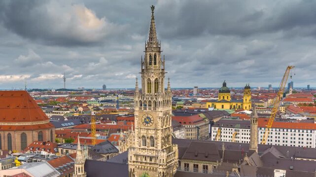 Timelapse of the Munich skyline featuring the iconic New Town Hall clock tower and the historic city center beneath dramatic storm clouds in Bavaria, Germany.