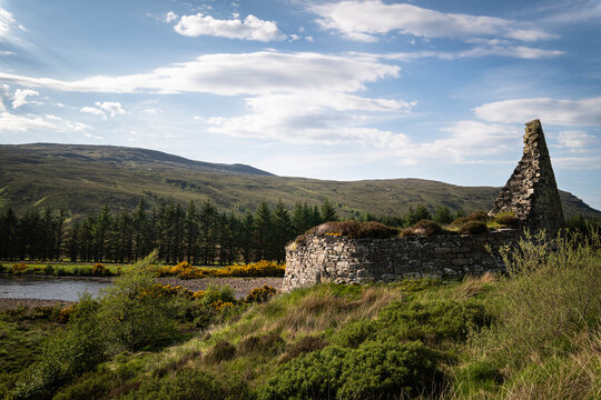 A bright summer, wide angled HDR landscape image of the remains of the Iron Age Broch, Dun Dornaigil in Strath more, Sutherland, Scotland