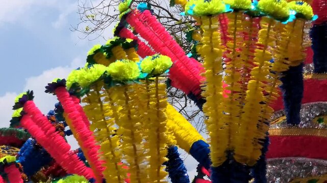 Closeup of colorful spinning structures traditionally used in the 'Kavadi' procession of temple festivals in South India