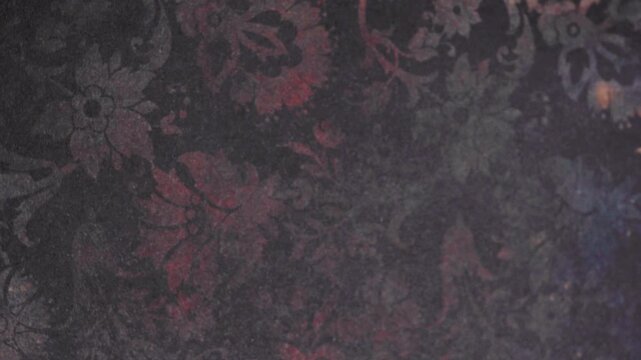 Close Up Shot of Dark Vintage Floral Damask Pattern with Red and Purple Highlights