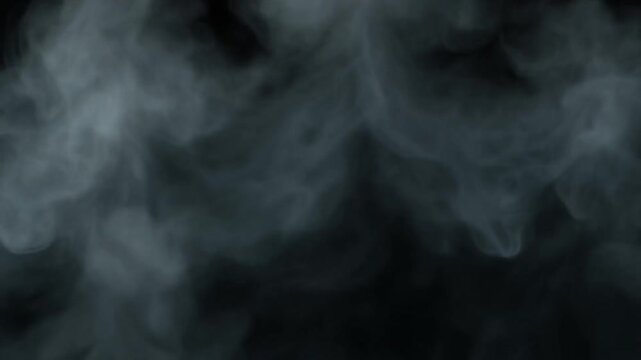 Abstract white vapor swirls rising against dark background